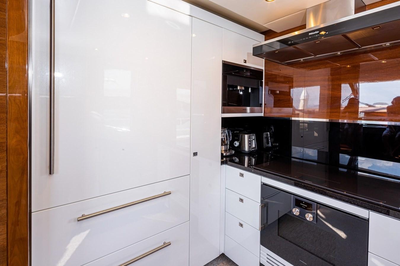 a kitchen with white cabinets aboard OCEAN Yacht for Sale