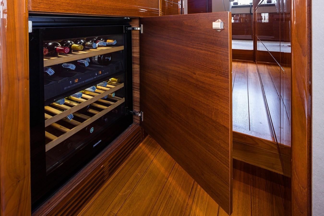 a wood cabinet with a glass door aboard OCEAN Yacht for Sale