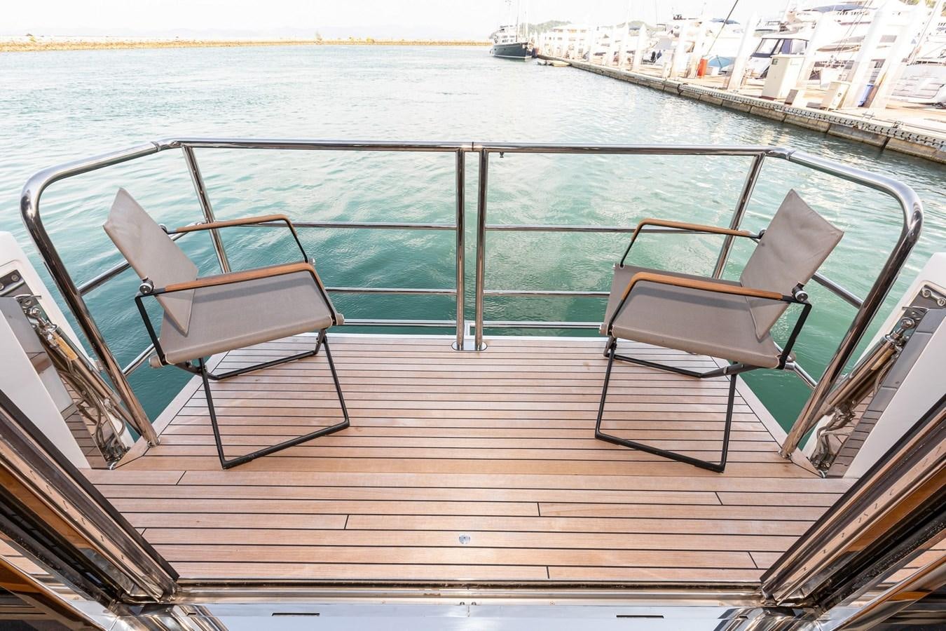 a deck with chairs on it aboard OCEAN Yacht for Sale