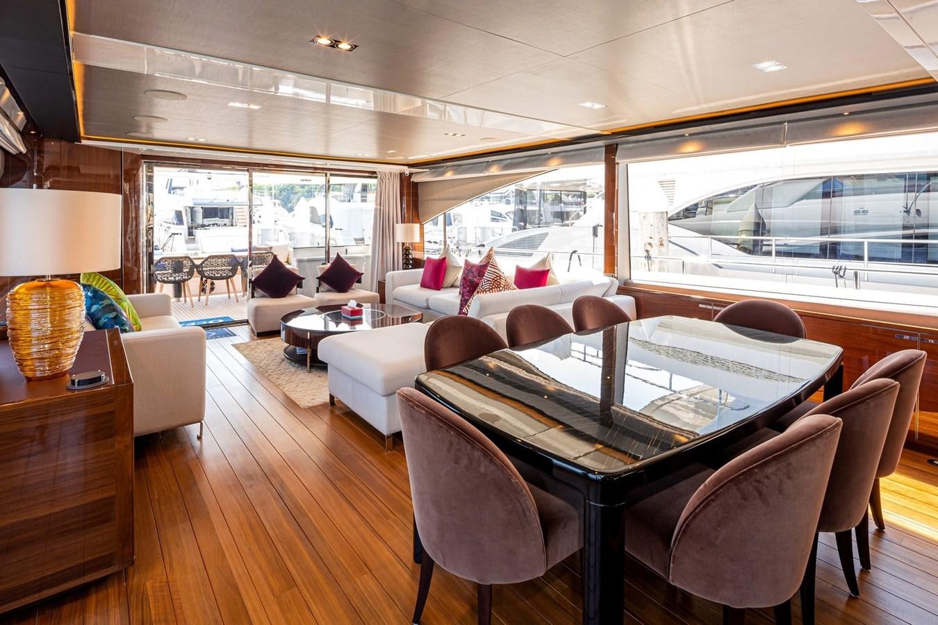 a large living room with a large table and chairs aboard OCEAN Yacht for Sale