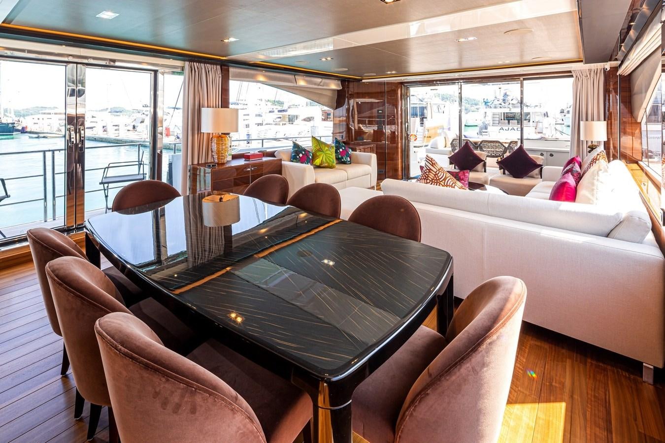 a living room with a large table aboard OCEAN Yacht for Sale