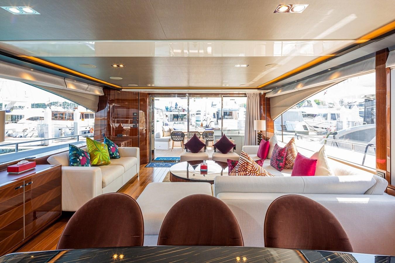 a room with a couch and a table and chairs aboard OCEAN Yacht for Sale