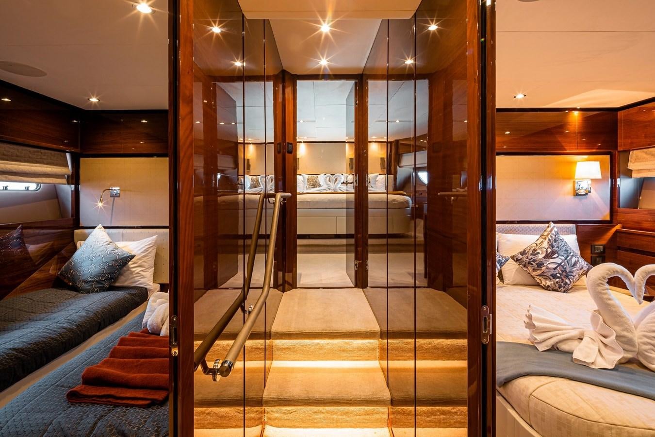 a room with a bed and a glass door aboard OCEAN Yacht for Sale