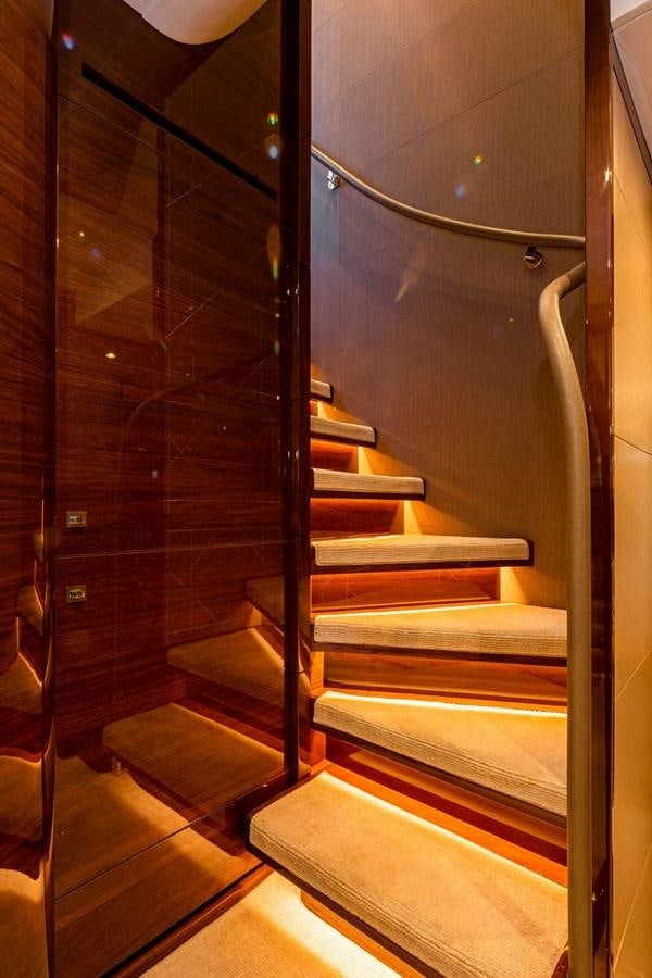 a staircase with glass walls aboard OCEAN Yacht for Sale