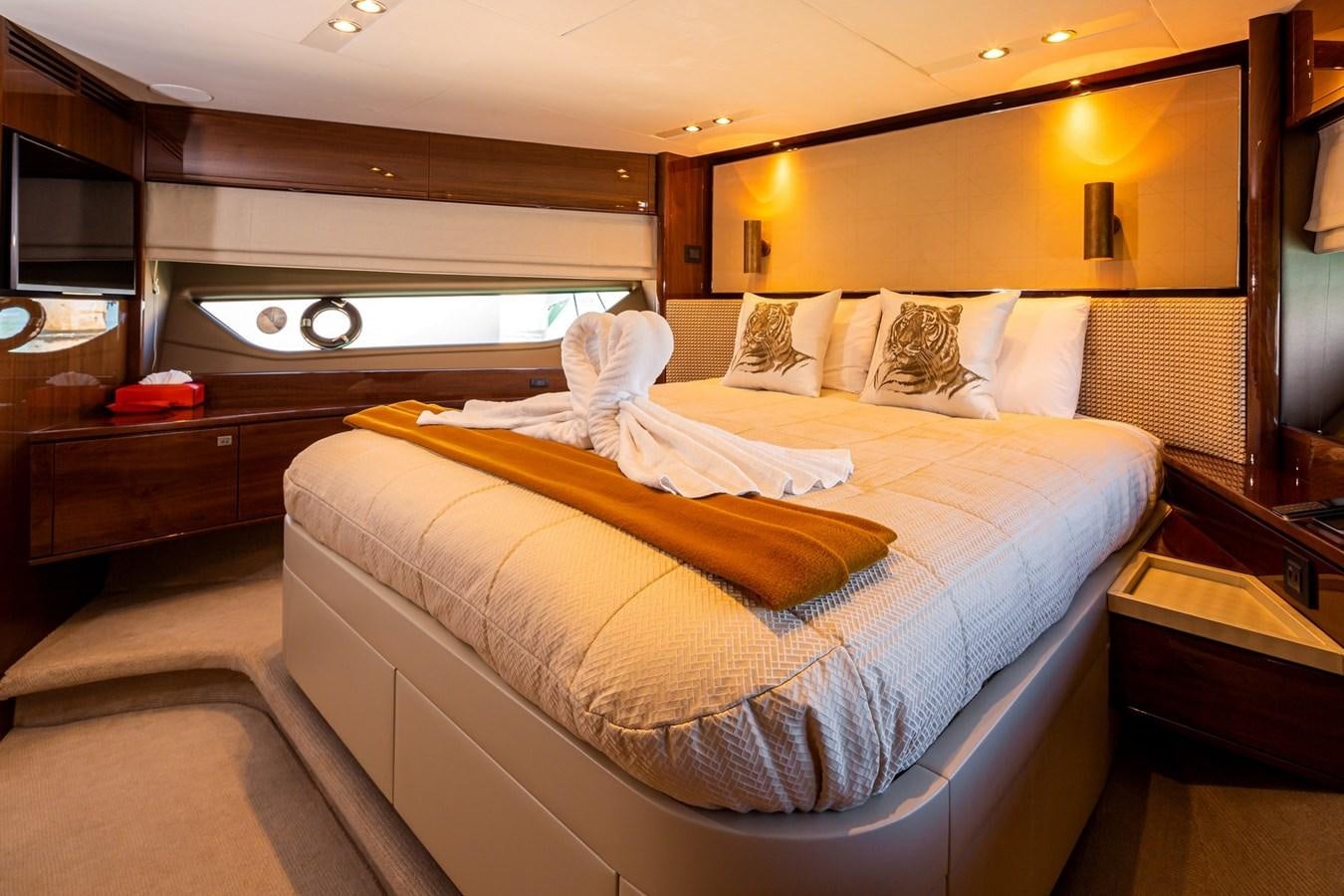 a bedroom with a bed and a television aboard OCEAN Yacht for Sale