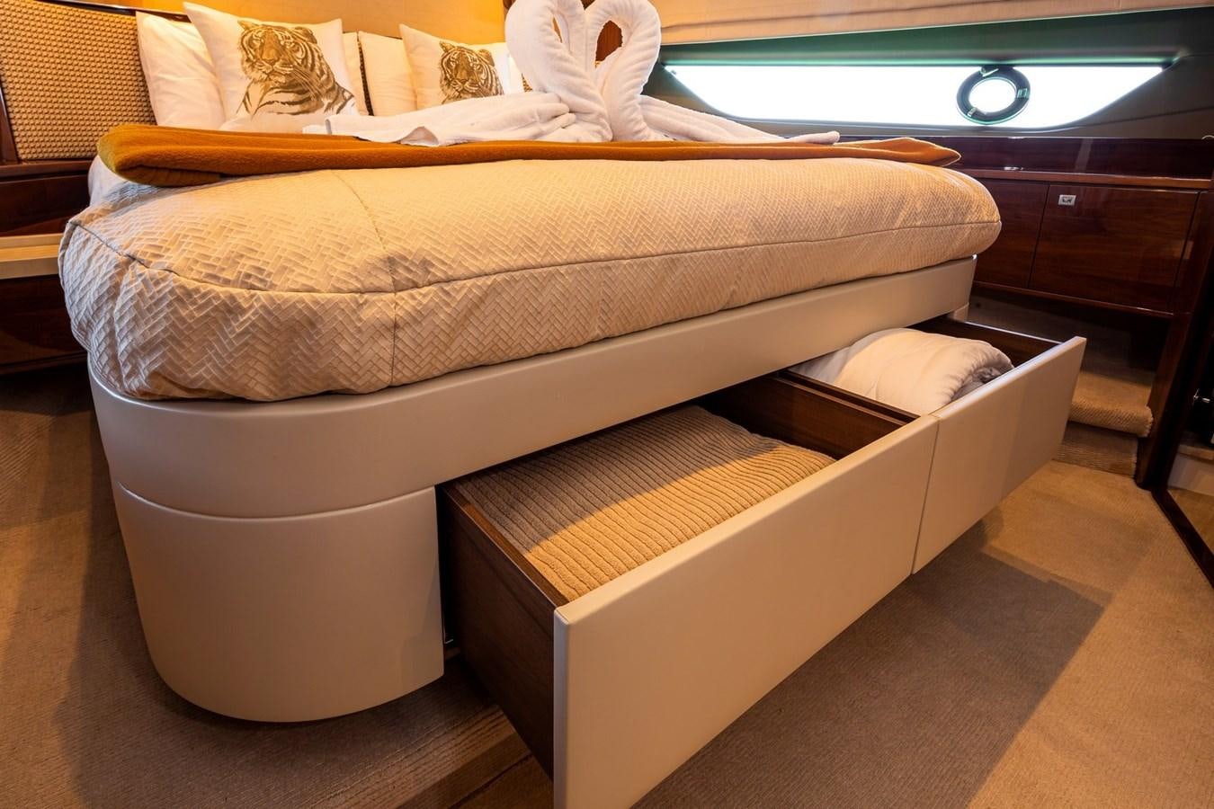 a bed with a white cover aboard OCEAN Yacht for Sale