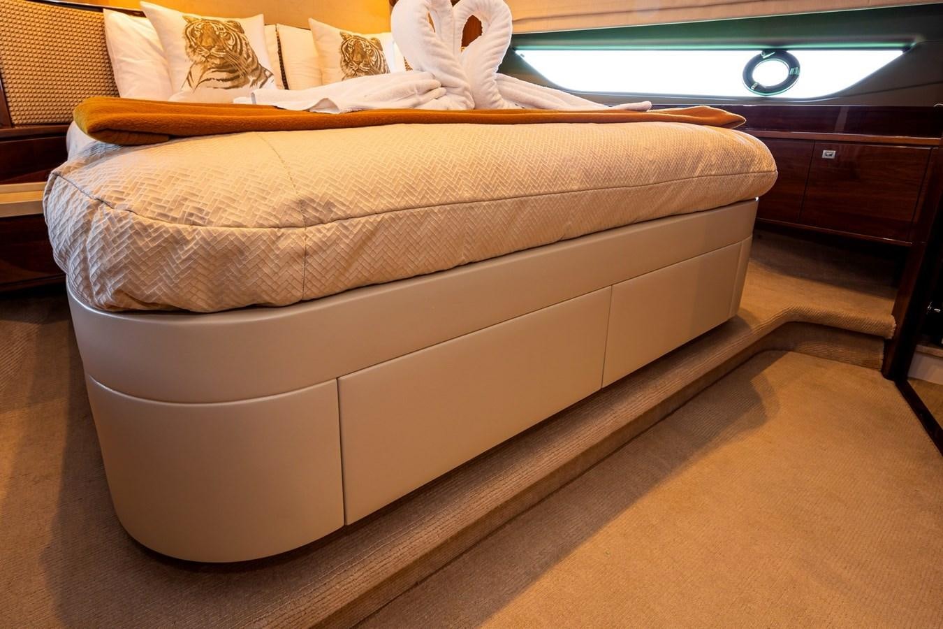 a bed with a white cover aboard OCEAN Yacht for Sale
