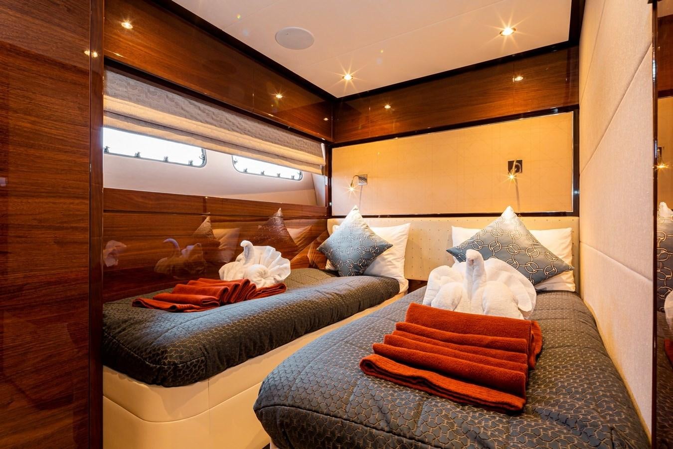 a bed with a couple of pillows aboard OCEAN Yacht for Sale