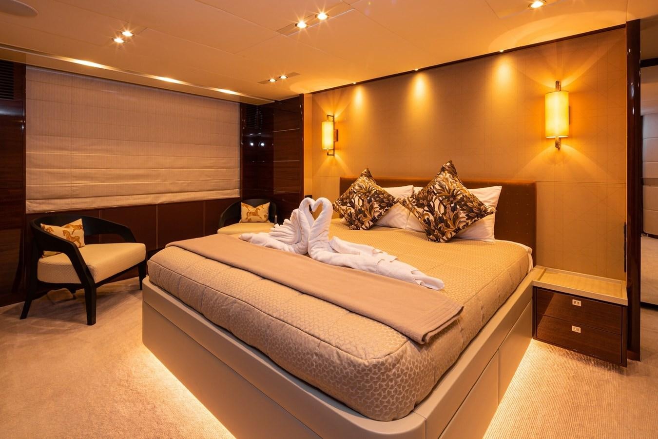 a bed with a white sheet on it aboard OCEAN Yacht for Sale