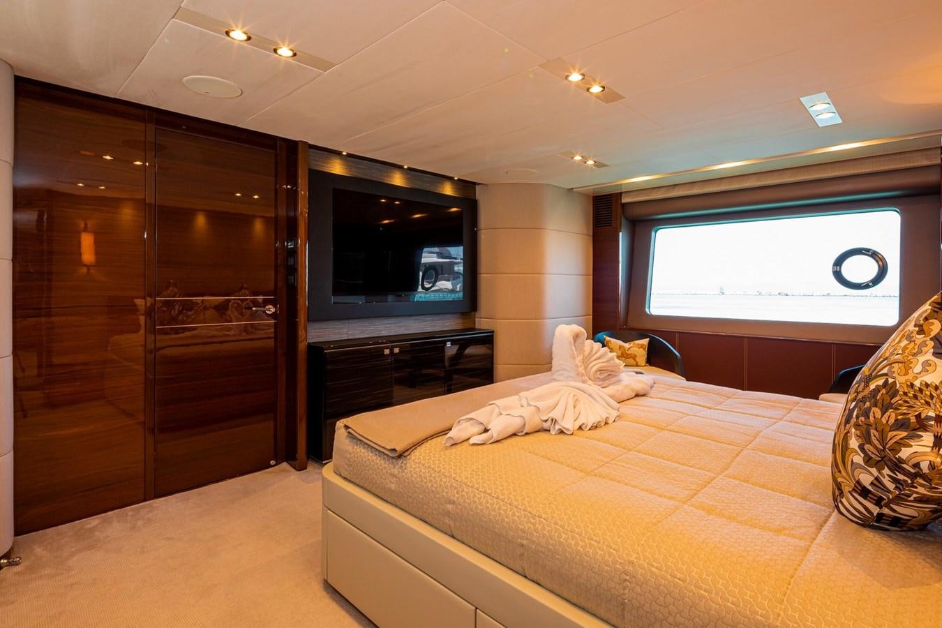 a bedroom with a bed and tv aboard OCEAN Yacht for Sale