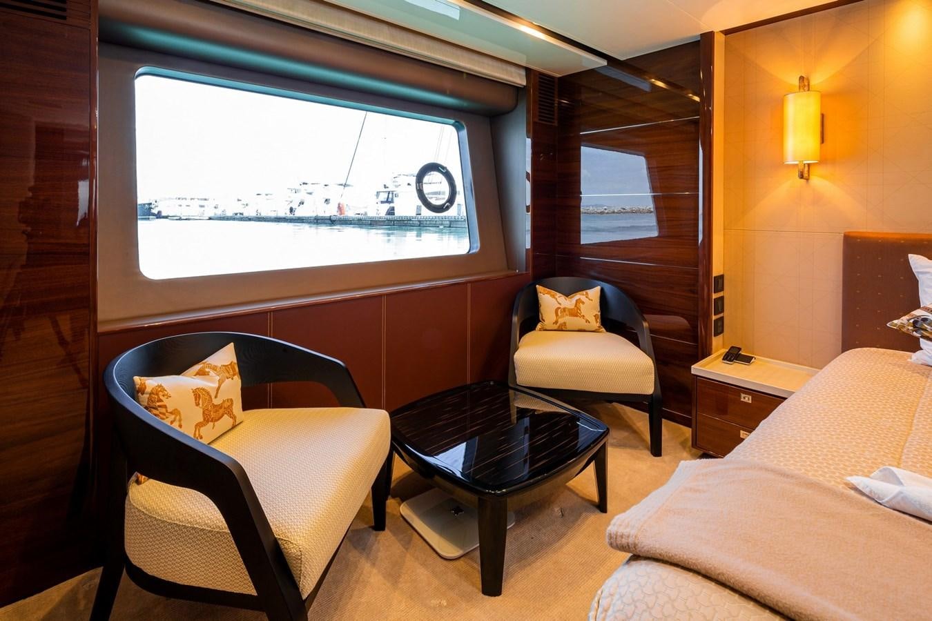 a room with a couch and a table and a window aboard OCEAN Yacht for Sale