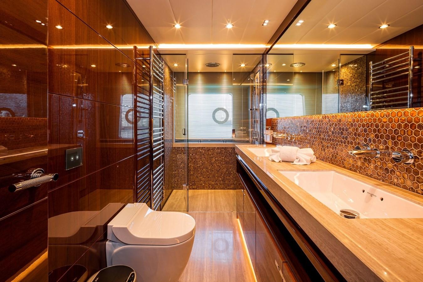 a bathroom with a tub sink and toilet aboard OCEAN Yacht for Sale