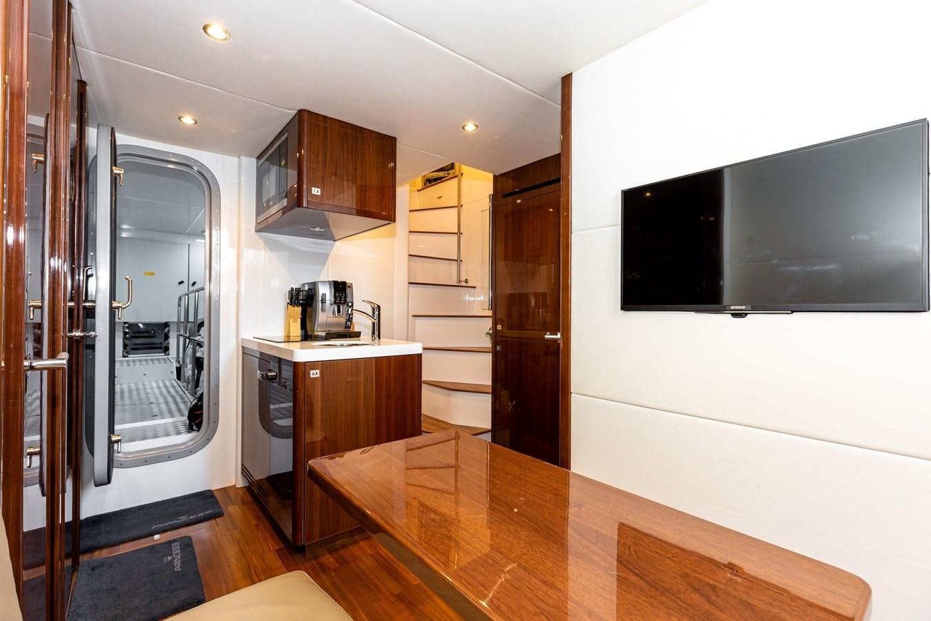 a kitchen with a large island aboard OCEAN Yacht for Sale