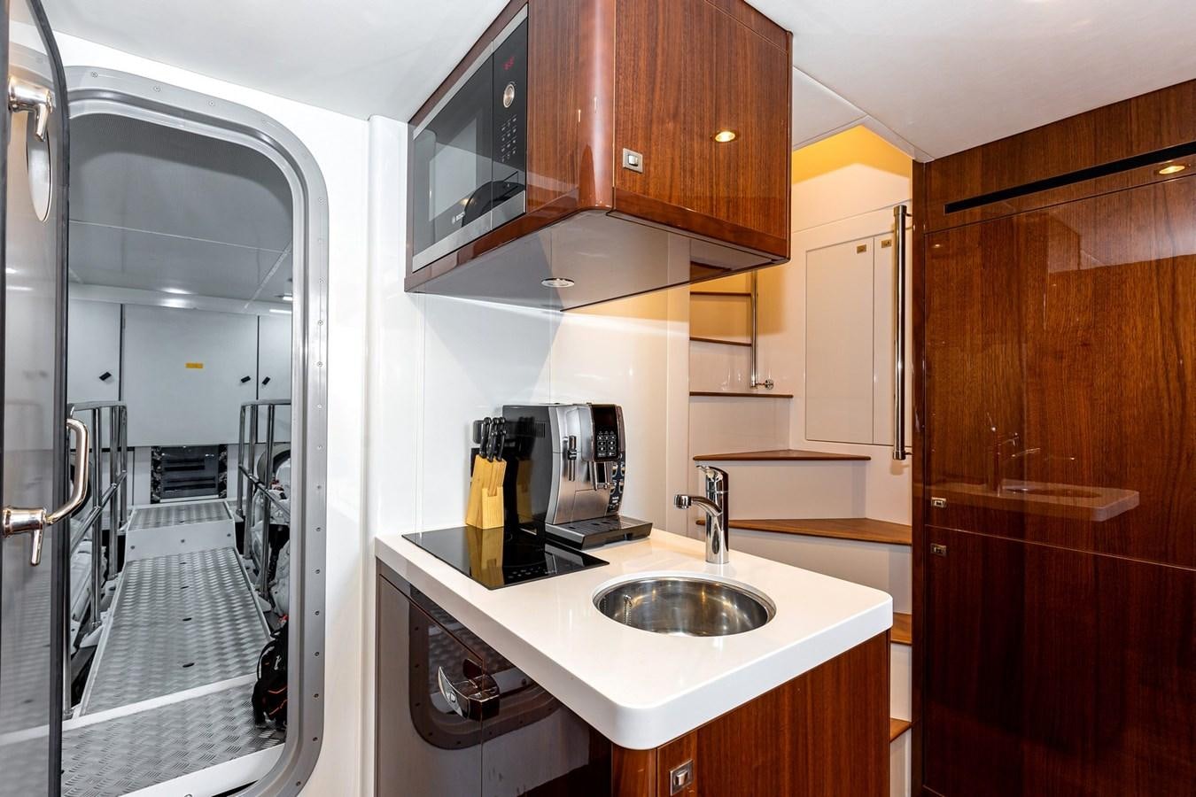 a kitchen with a sink and a door aboard OCEAN Yacht for Sale