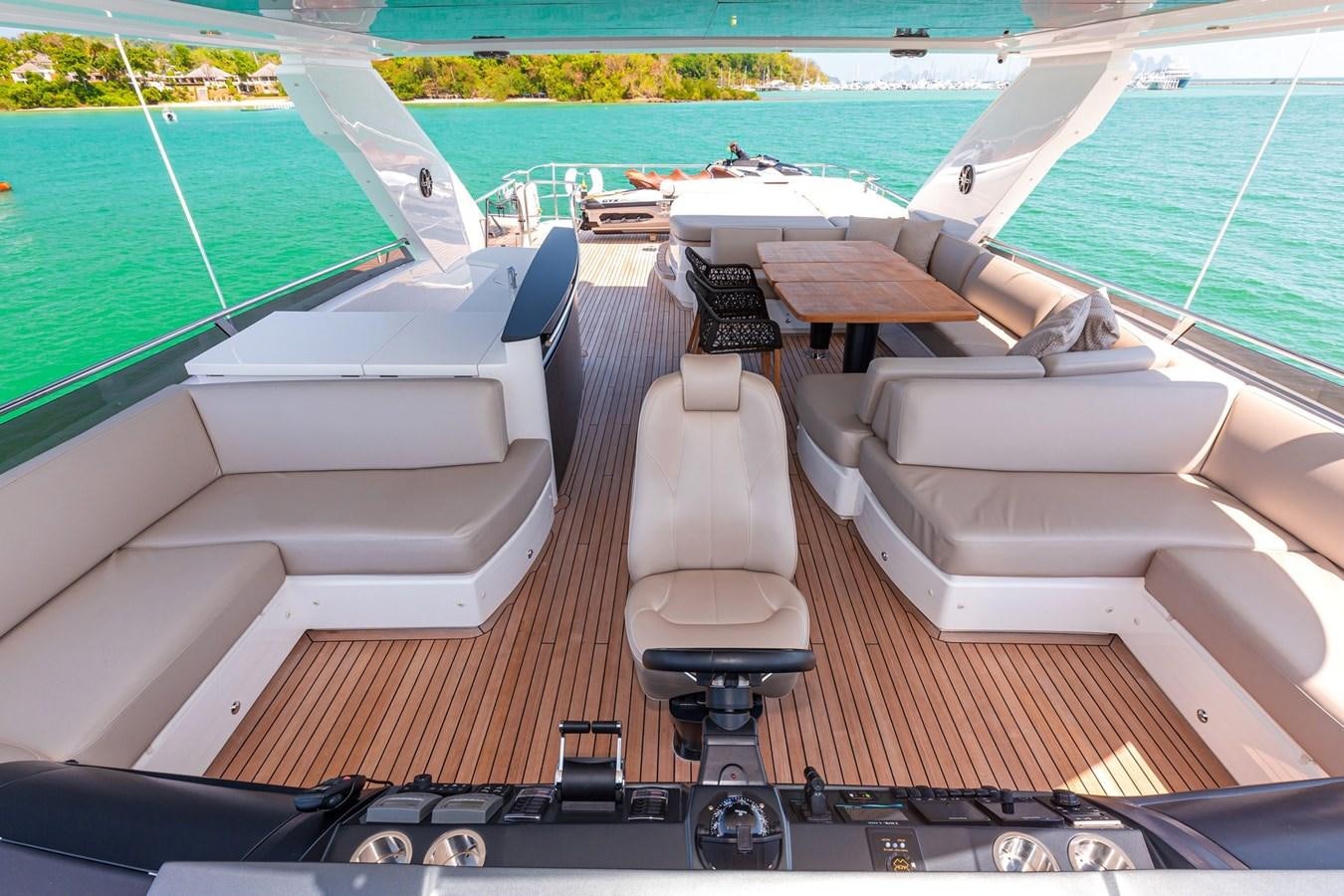 a deck with a pool and a deck with chairs and a deck aboard OCEAN Yacht for Sale