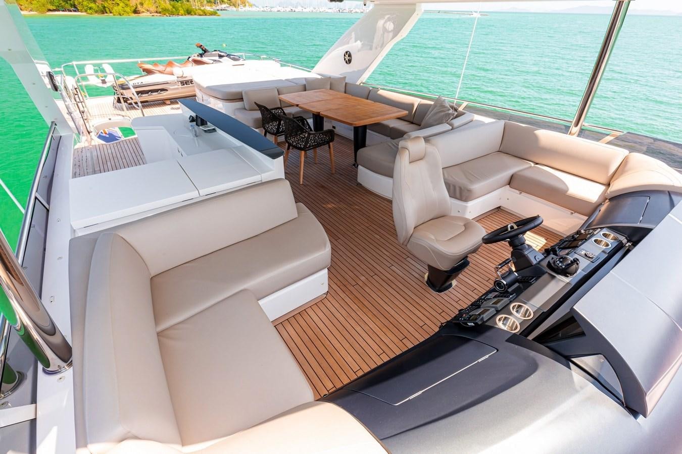 a room with a pool and a deck with chairs and tables aboard OCEAN Yacht for Sale