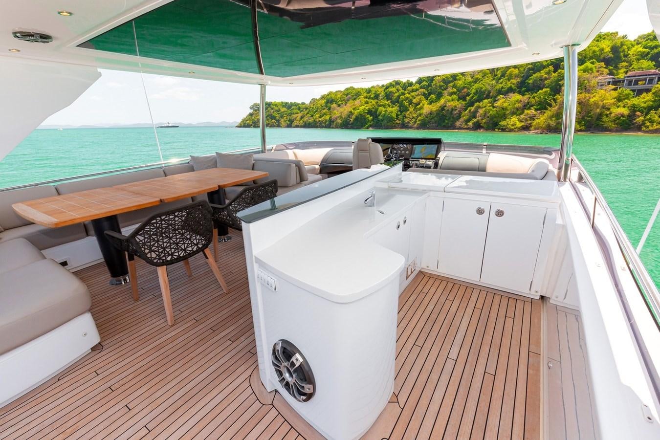 a white tub and a table in a room with a table and chairs aboard OCEAN Yacht for Sale