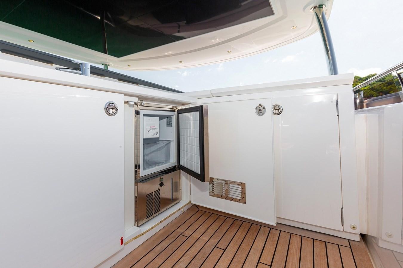 a white kitchen with a wood floor aboard OCEAN Yacht for Sale