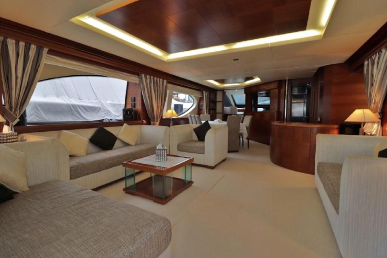 a room with a couch and a table and a television aboard AZIMUT AZ 85/124 Yacht for Sale