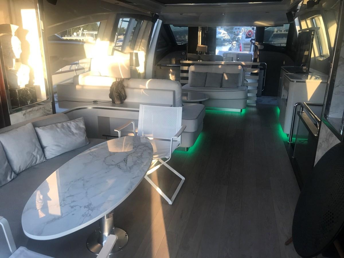 a room with a couch and a table aboard PATRIOT Yacht for Sale