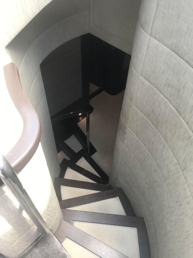 a staircase with a white wall aboard PATRIOT Yacht for Sale