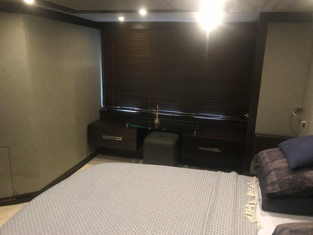 a room with a bed and a desk aboard PATRIOT Yacht for Sale