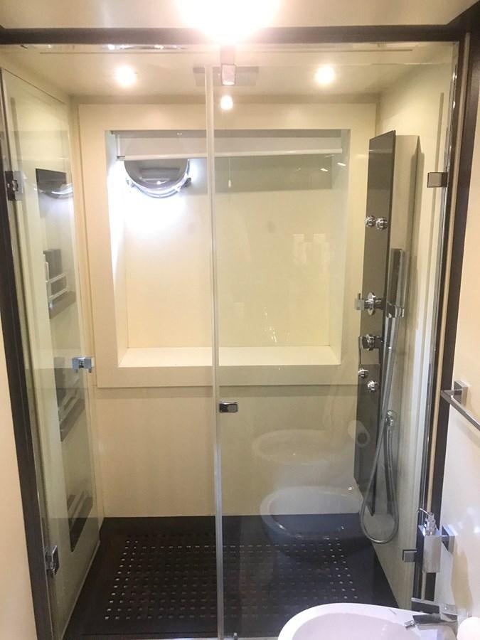 a bathroom with a glass shower aboard PATRIOT Yacht for Sale