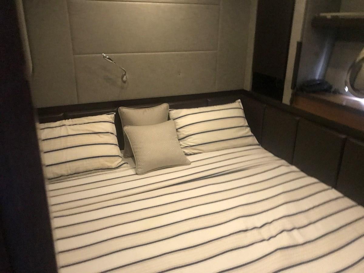 a bed with white sheets aboard PATRIOT Yacht for Sale