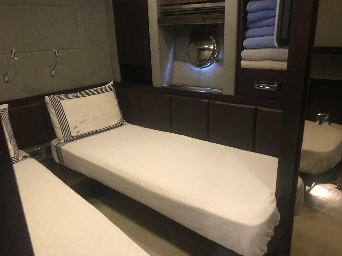 a bed with a white cover aboard PATRIOT Yacht for Sale