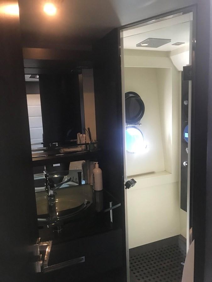a bathroom with a large mirror aboard PATRIOT Yacht for Sale