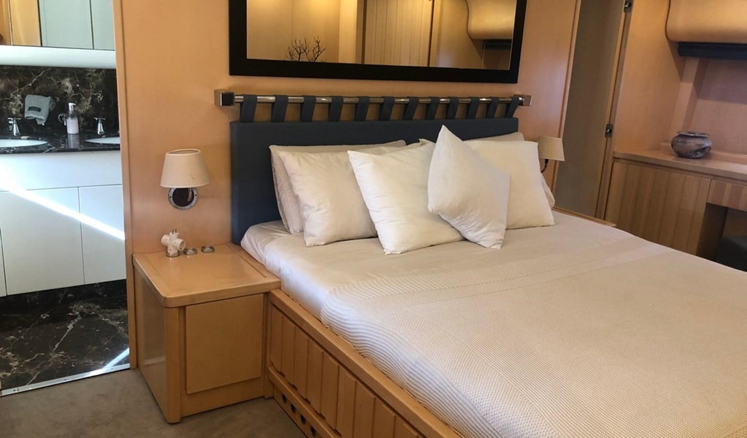 a bed with white sheets aboard AYA Yacht for Sale