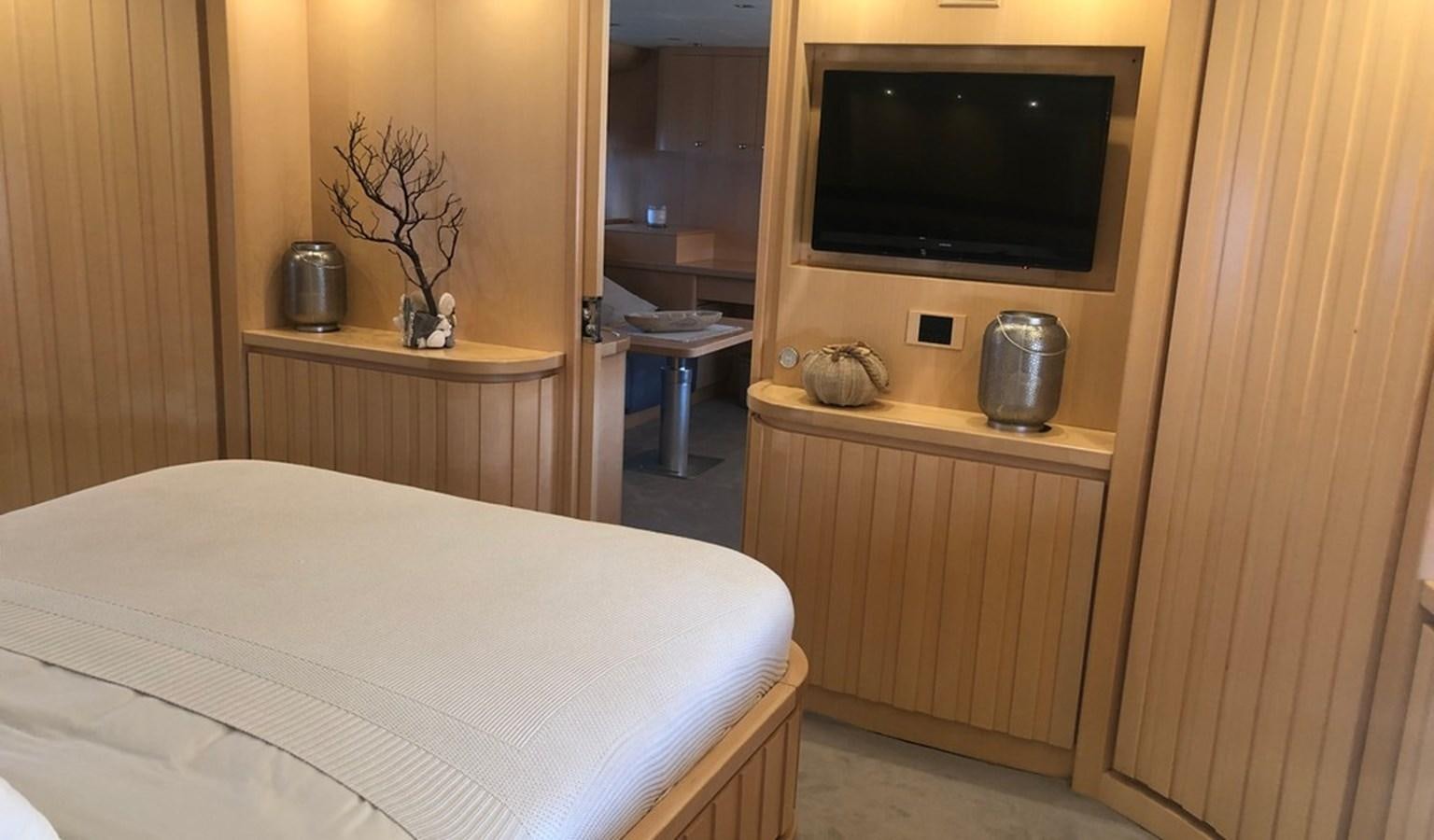 a room with a television and a bed aboard AYA Yacht for Sale