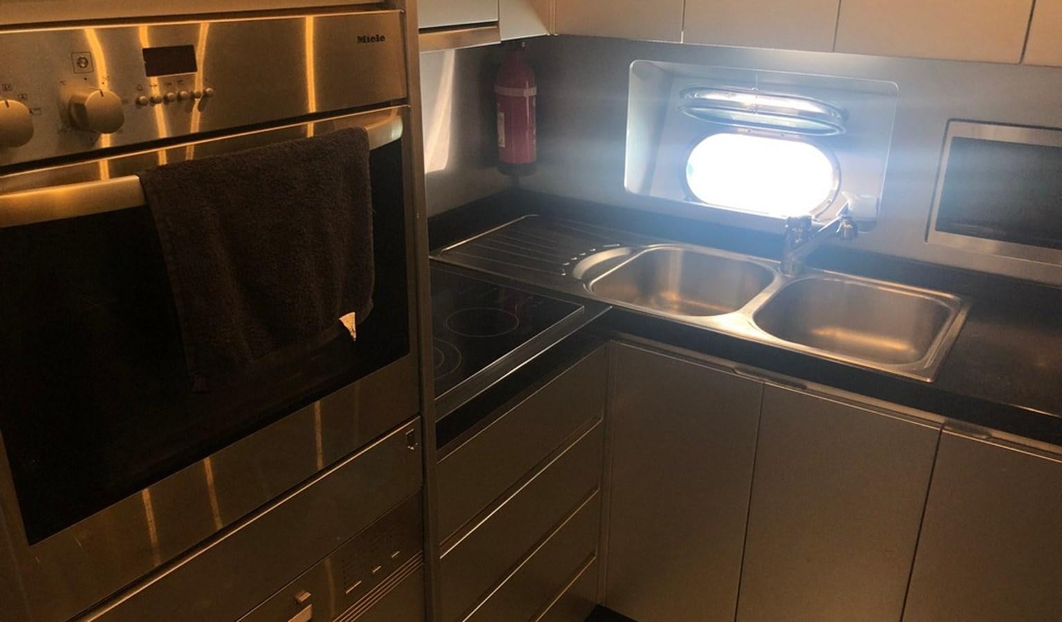 a kitchen with a sink and a microwave aboard AYA Yacht for Sale