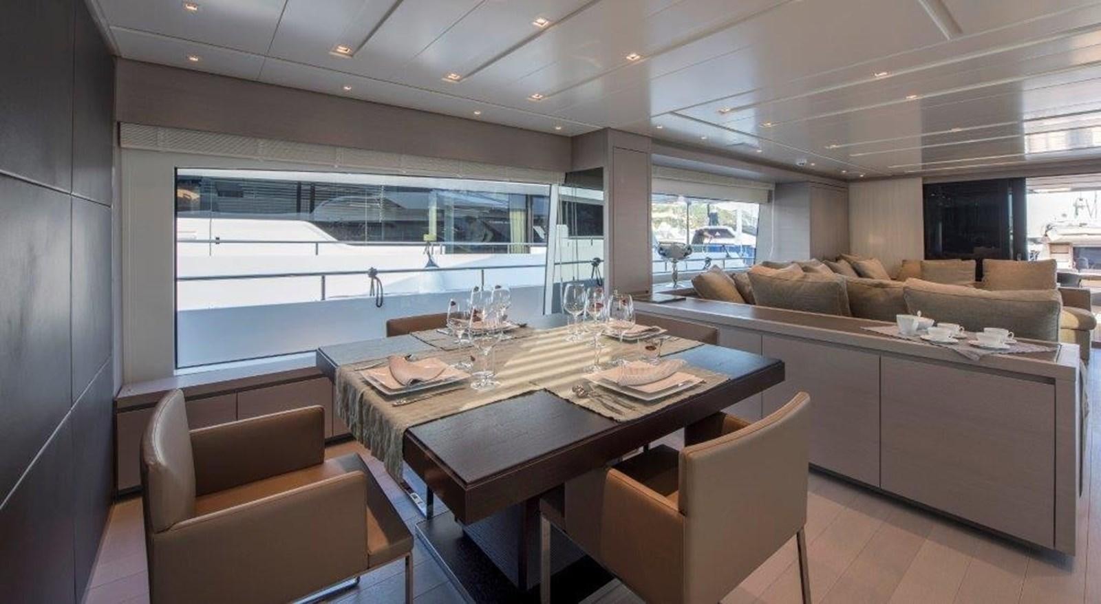 a large kitchen with a table aboard MAJOLA Yacht for Sale