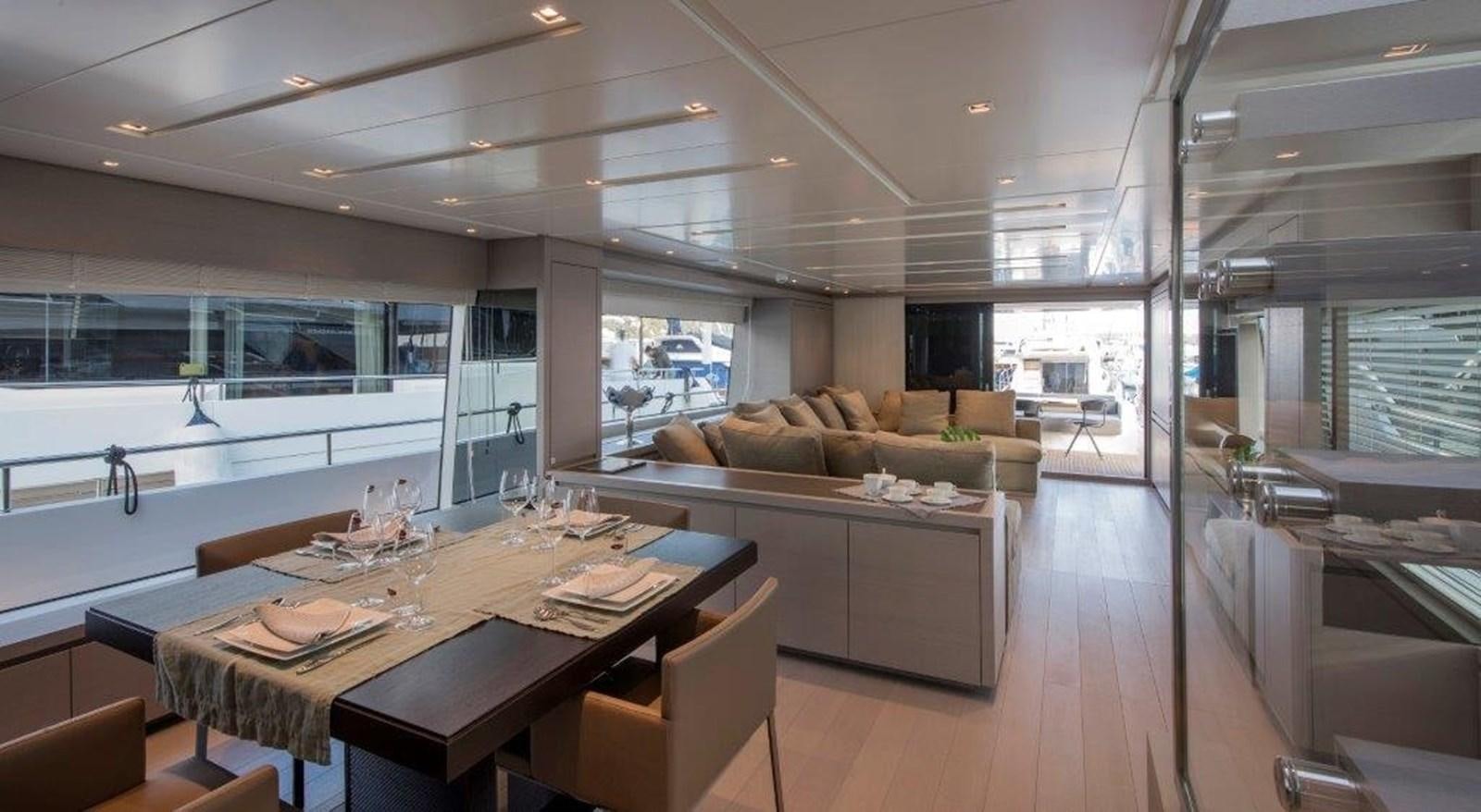 a large kitchen with a large table aboard MAJOLA Yacht for Sale