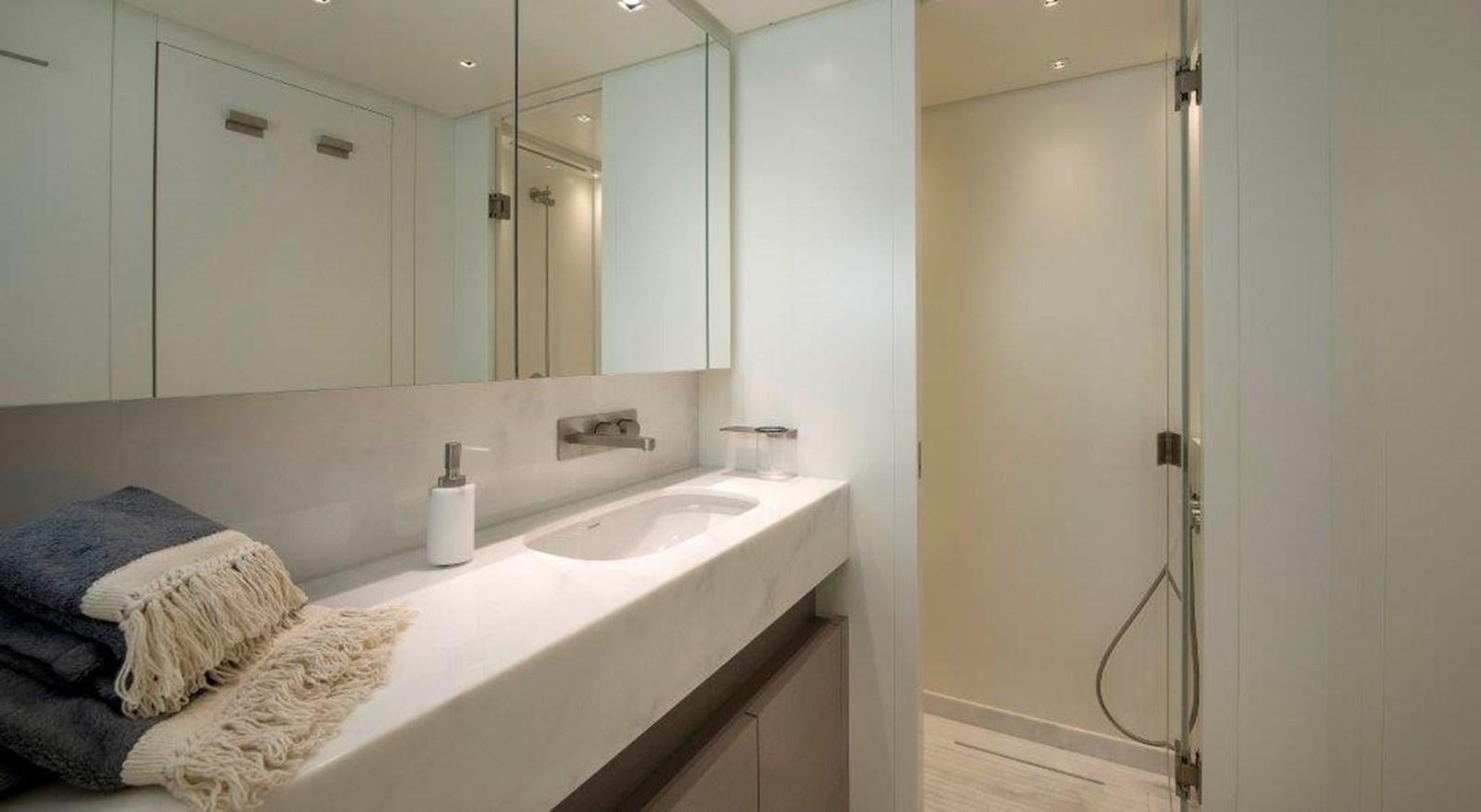 a bathroom with a large mirror aboard MAJOLA Yacht for Sale