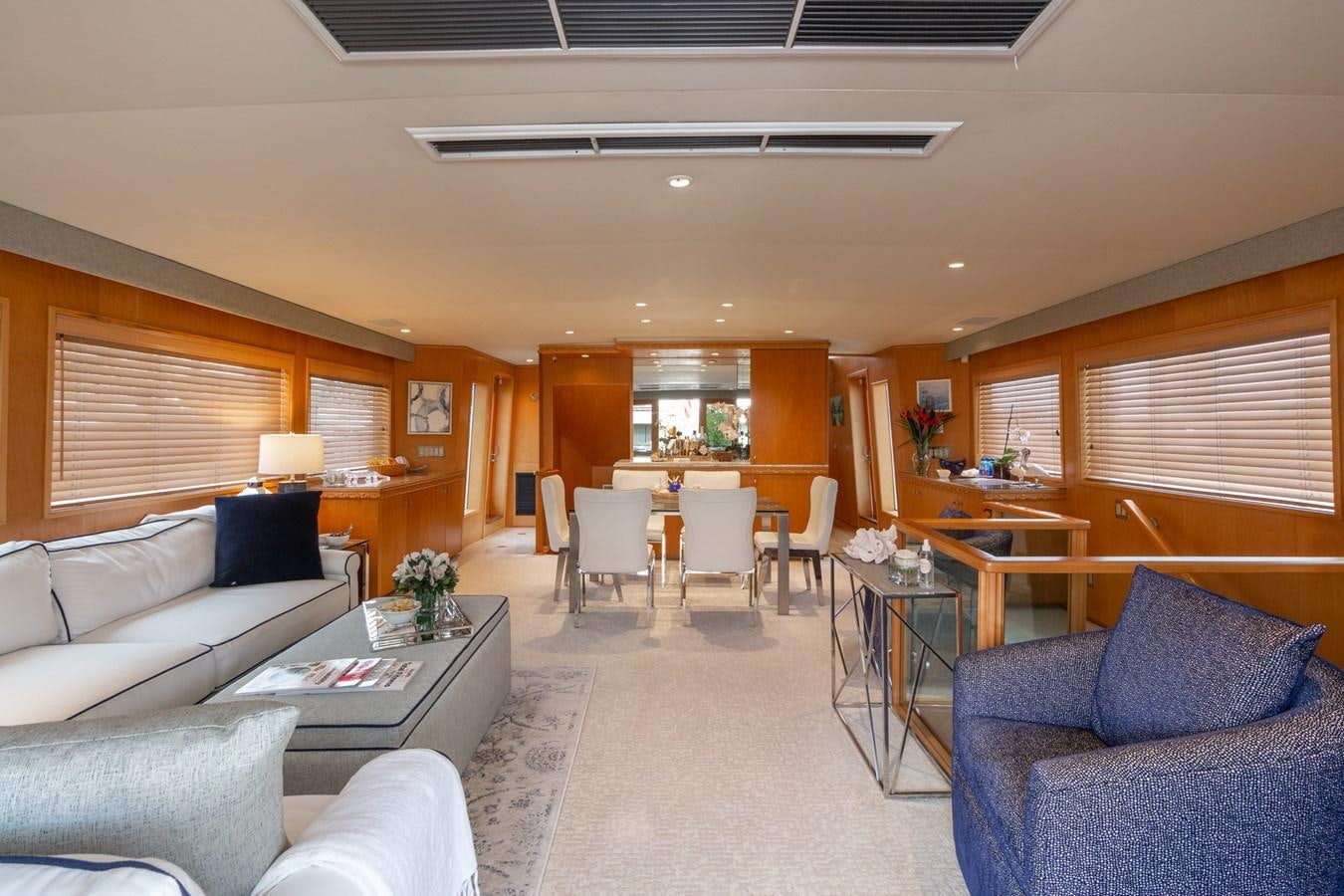 a living room with a couch and a table aboard UNLEASHED Yacht for Sale