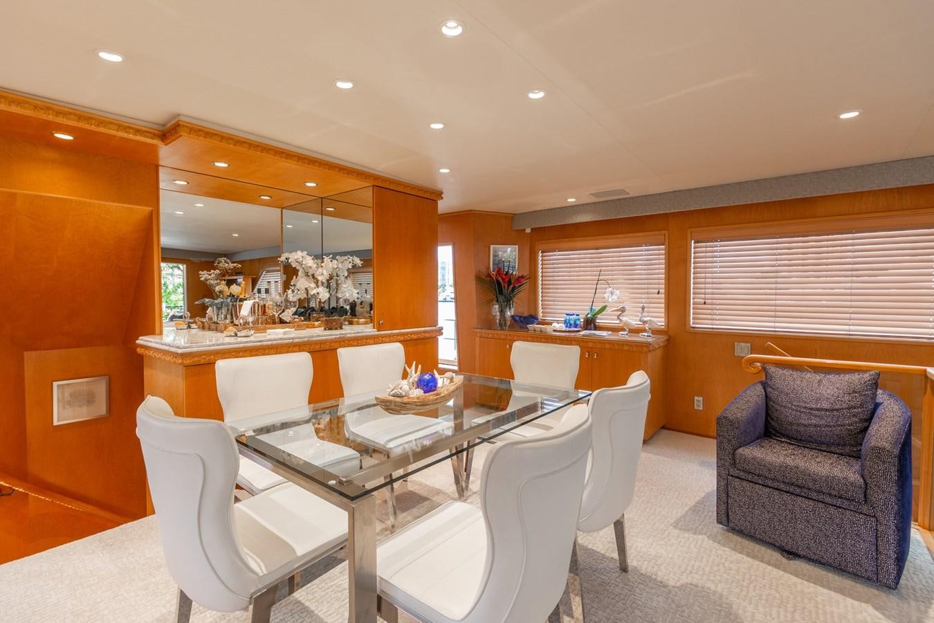 a room with a couch and a table and chairs aboard UNLEASHED Yacht for Sale