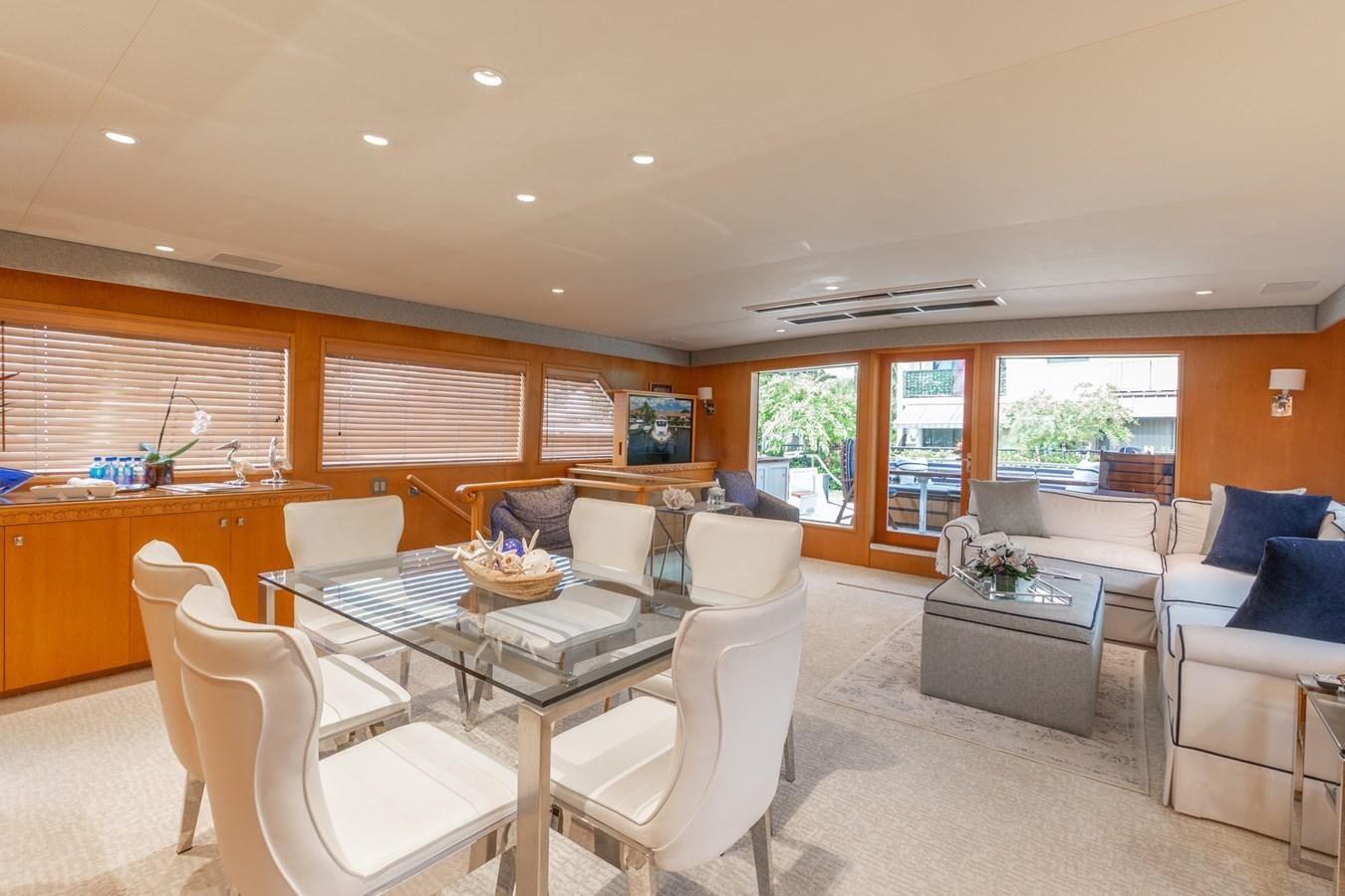 a large living room with a large table and chairs aboard UNLEASHED Yacht for Sale
