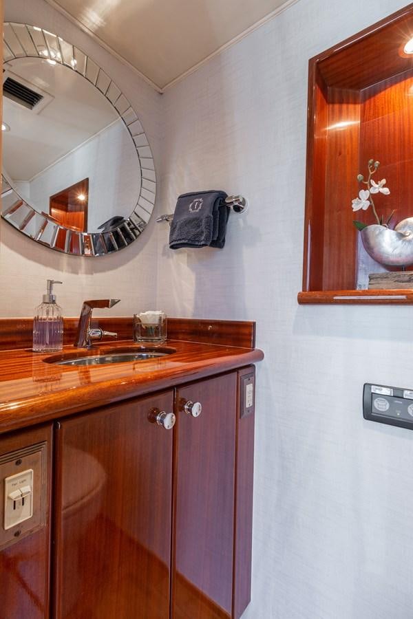 a bathroom with a sink and a mirror aboard UNLEASHED Yacht for Sale
