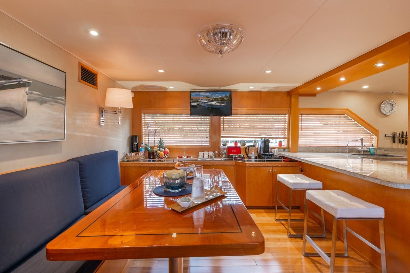 a large kitchen with a bar and a table aboard UNLEASHED Yacht for Sale