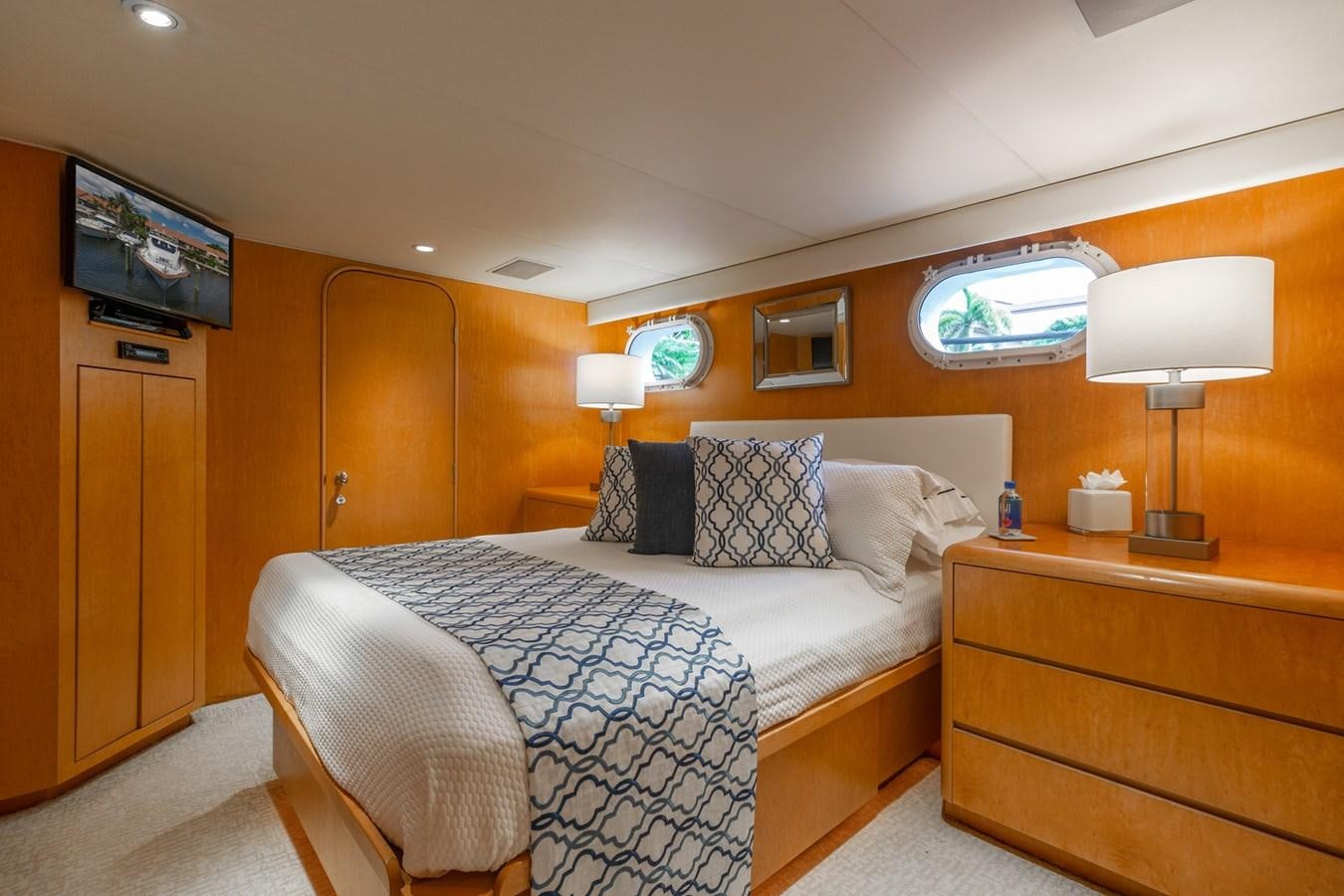 a bedroom with a bed and a television aboard UNLEASHED Yacht for Sale