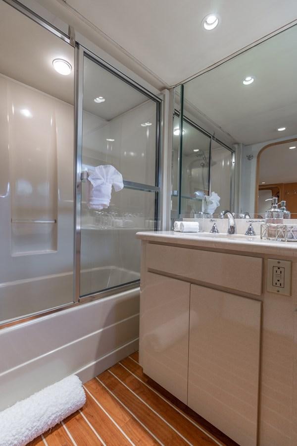 a bathroom with a glass shower aboard UNLEASHED Yacht for Sale