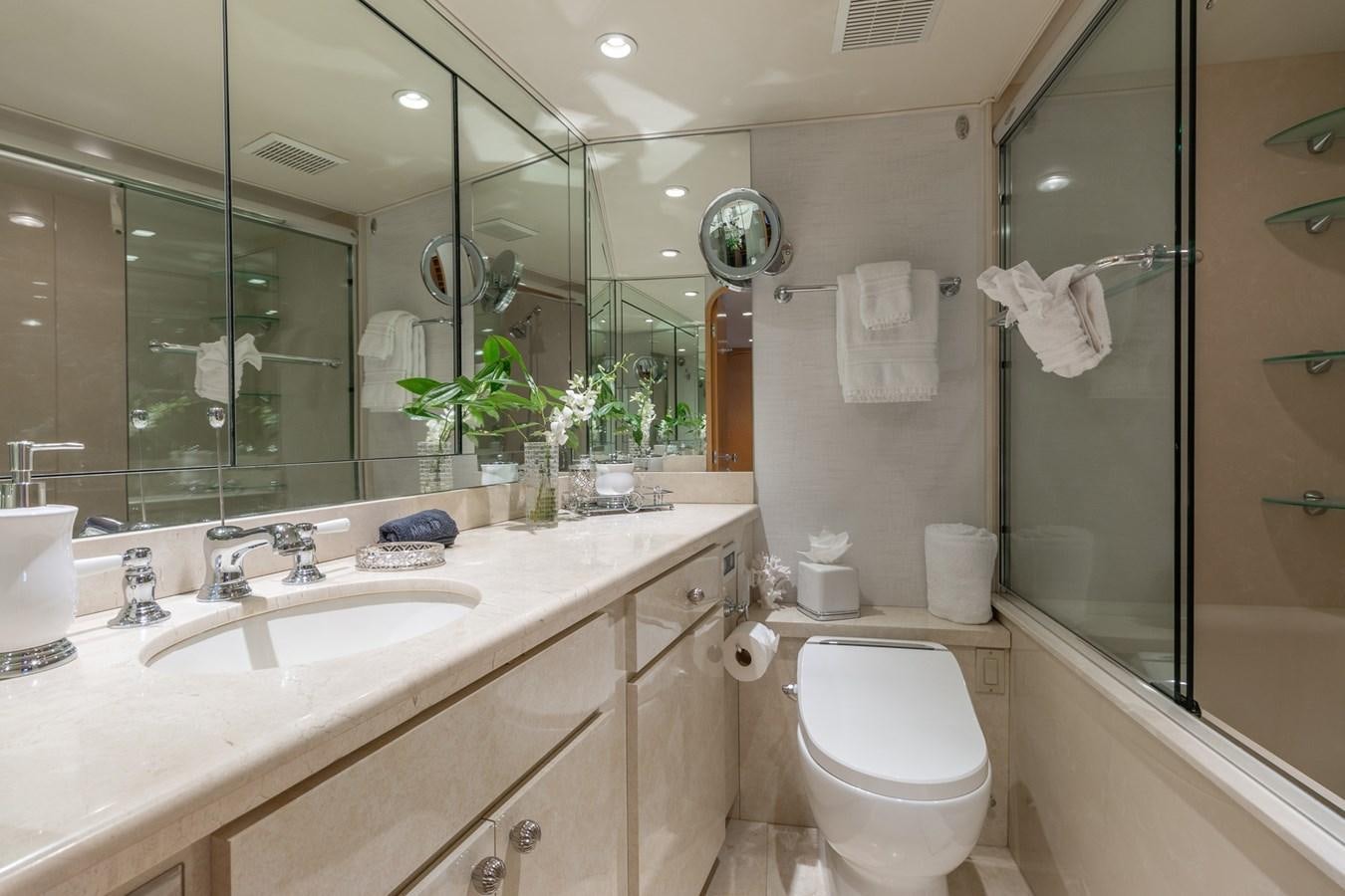 a bathroom with a toilet and a sink aboard UNLEASHED Yacht for Sale