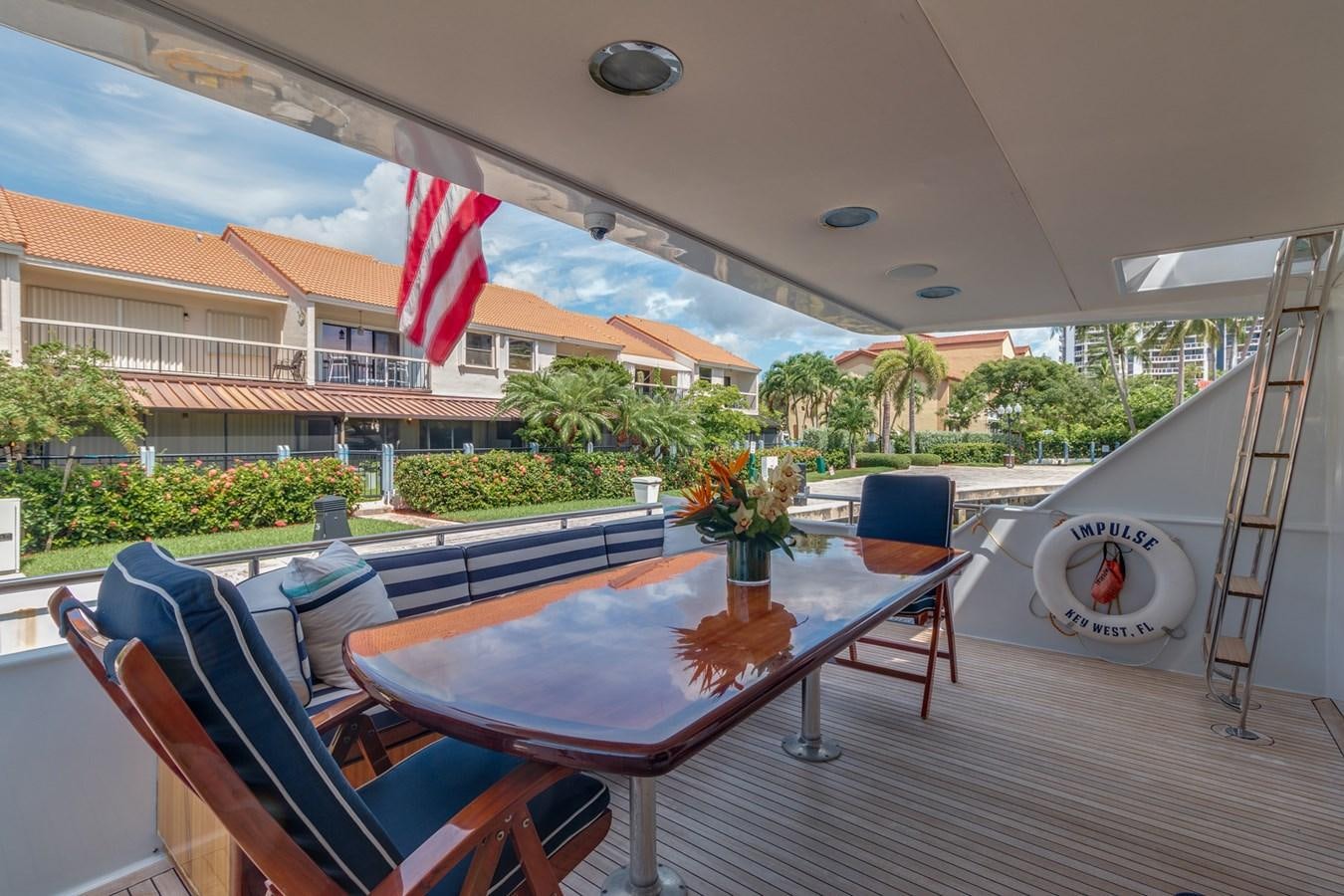 a patio with a table and chairs aboard UNLEASHED Yacht for Sale