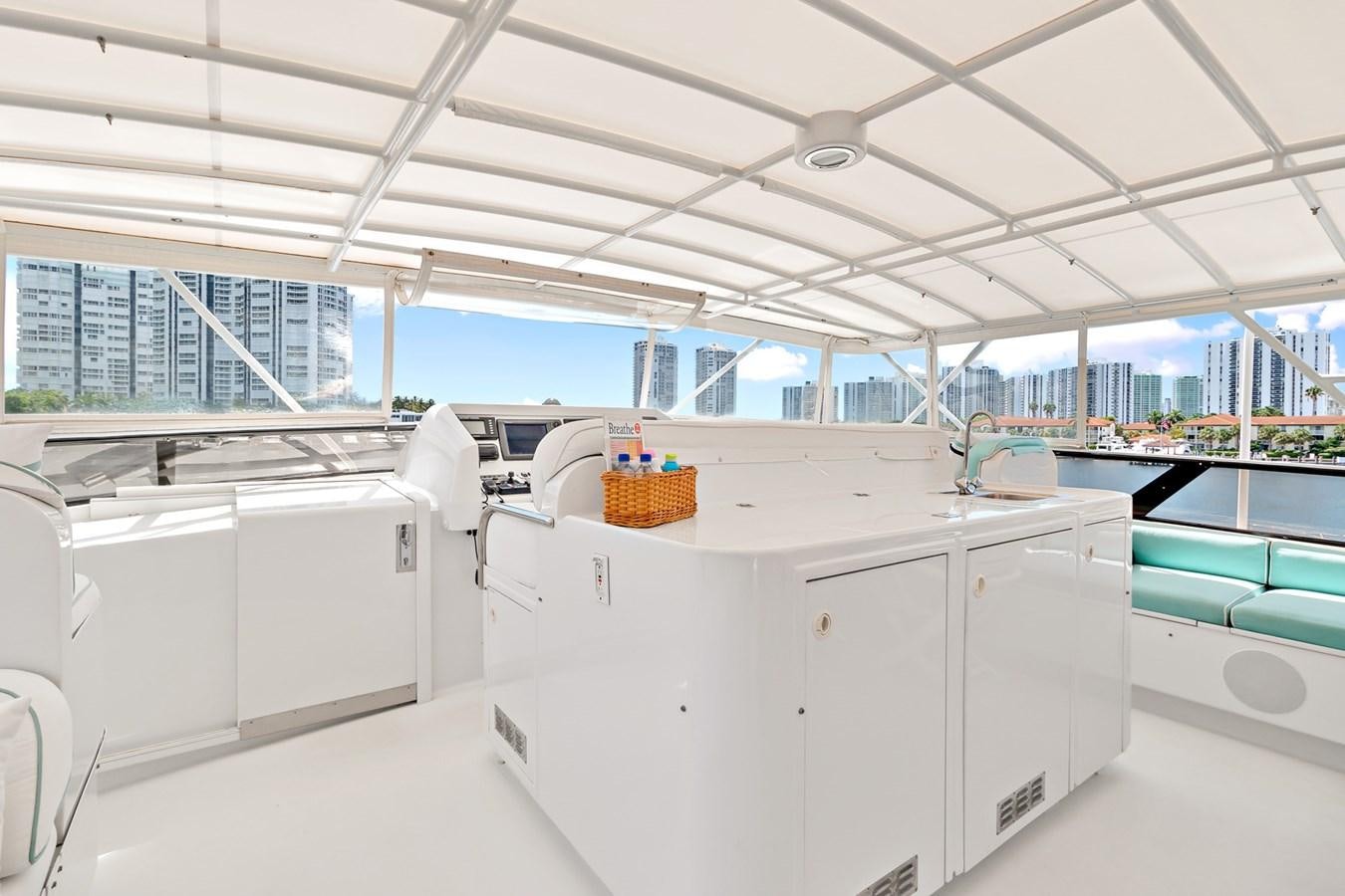 a large white kitchen with white cabinets aboard UNLEASHED Yacht for Sale