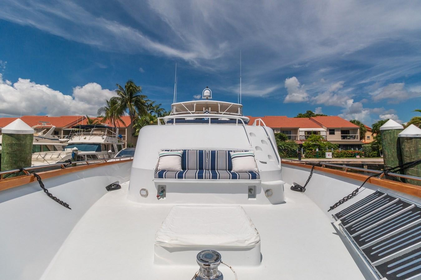 a white boat on a dock aboard UNLEASHED Yacht for Sale