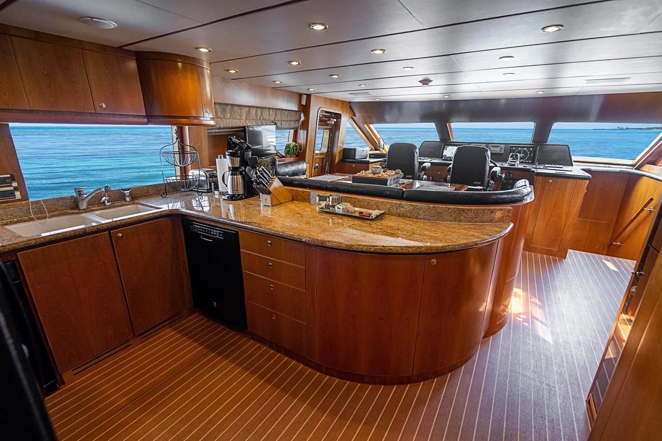 a large kitchen with wooden cabinets aboard ROXY MARIA Yacht for Sale