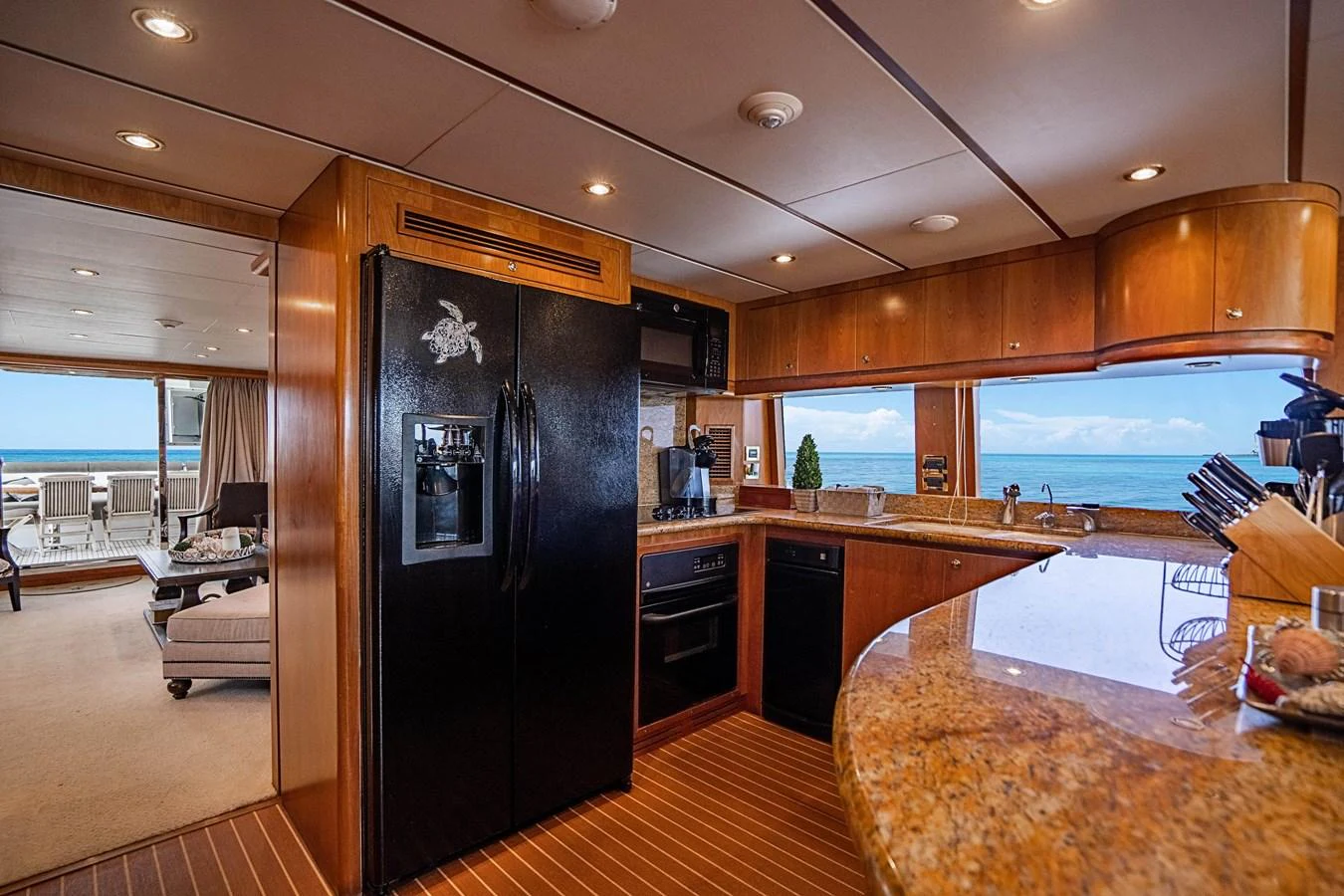 a kitchen with a large black refrigerator aboard ROXY MARIA Yacht for Sale