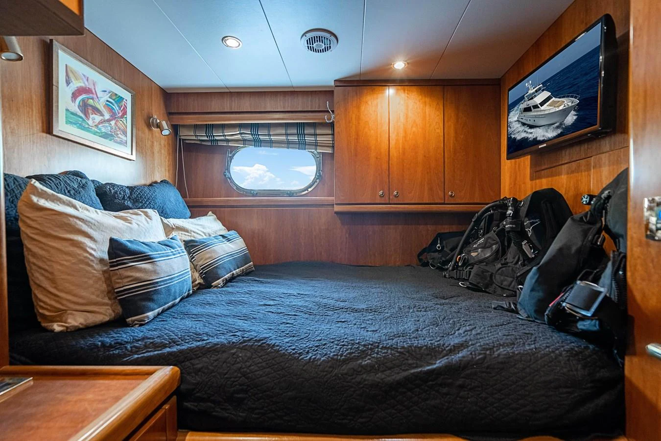 a bed with a blue comforter aboard ROXY MARIA Yacht for Sale